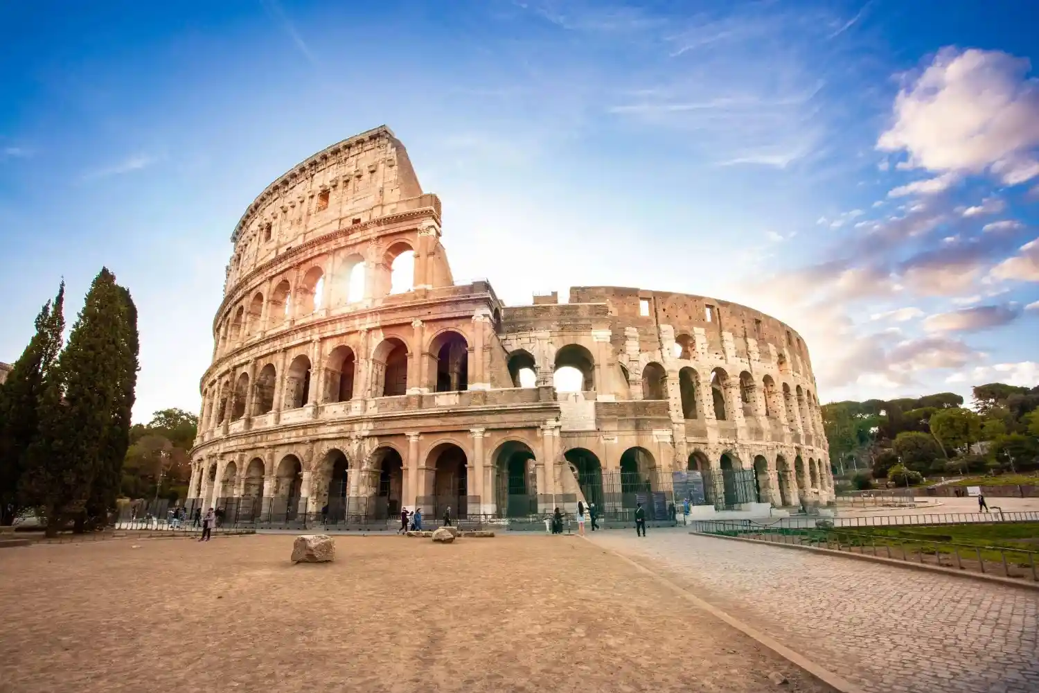 colosseum in the evening with the sun filtering through the arches